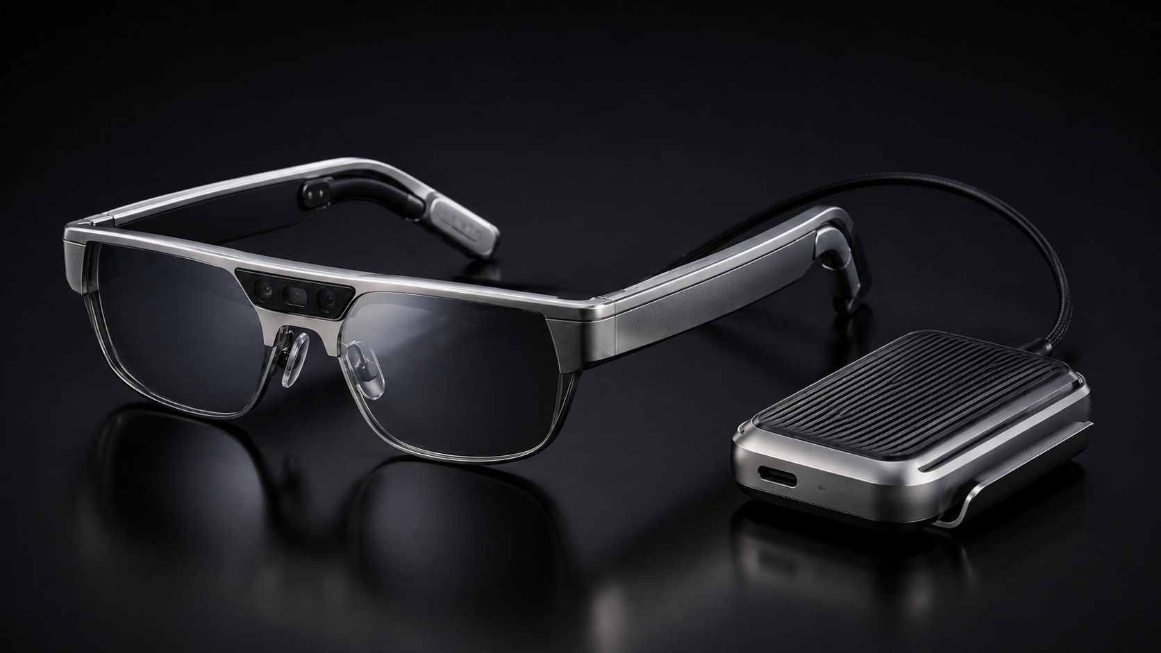 RM Lens eyewear in Titanium with RM Core on a dark surface